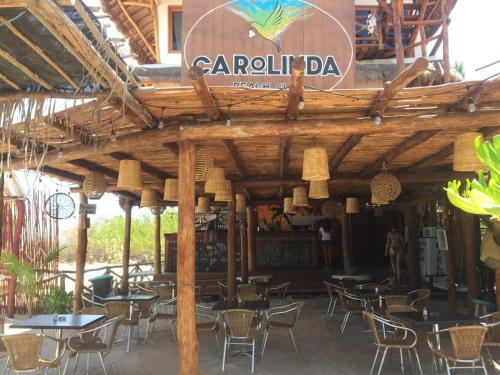 a restaurant with tables and chairs and a sign that reads carril da at Ensueño Holbox & Beach Club in Holbox Island