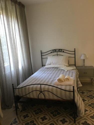 a bedroom with a bed with two slippers on it at Via Mazzini in Bazzano