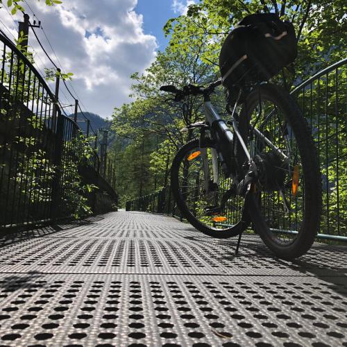 a bike parked next to a fence on a street at Landhaus Lilly in Obertraun
