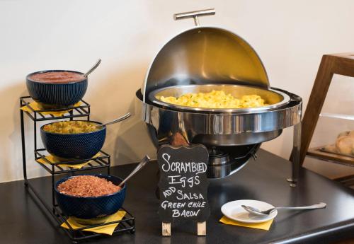 a buffet with bowls of food on a table at The Sage Hotel in Santa Fe