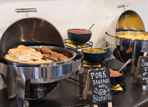 a buffet of food on a counter with bowls of food at The Sage Hotel in Santa Fe
