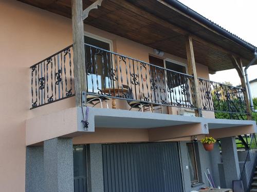 a balcony of a house with a table and chairs at U Władzia in Gowidlino