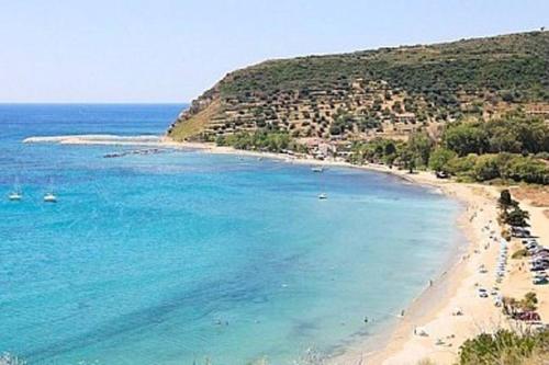 a beach with a bunch of people on the water at Sunny Coco mat villa in Katelios with a sea view in Katelios