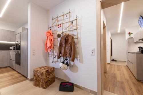 a room with a white wall with a coat rack at ImPuls | aparts in Schladming