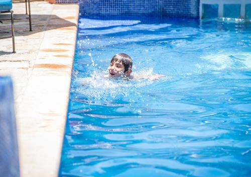 a boy swimming in a swimming pool at Casa Estrella de la Valenciana Hotel Boutique in Guanajuato