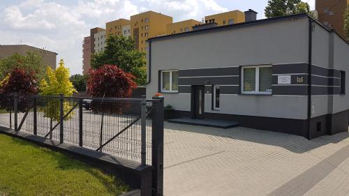 a house with a fence in front of it at Apartament Angelo in Sosnowiec