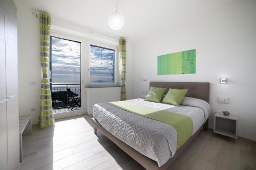 a bedroom with a bed and a window at Villa Bellatrix in Massa Lubrense