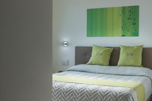 a bedroom with a bed with yellow pillows at Villa Bellatrix in Massa Lubrense