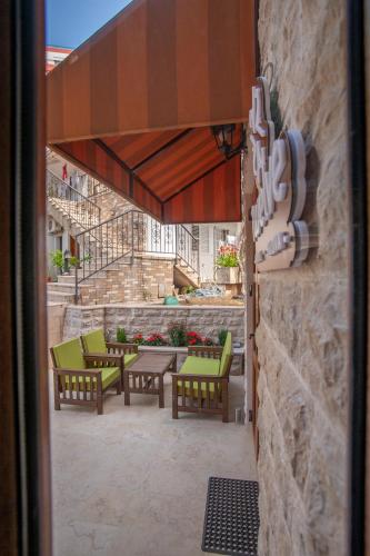 a view of a patio with green chairs and tables at Hotel Twelve by Aycon in Budva