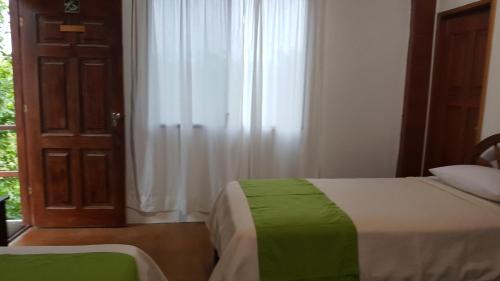 Postel nebo postele na pokoji v ubytování Hotel La Jungla