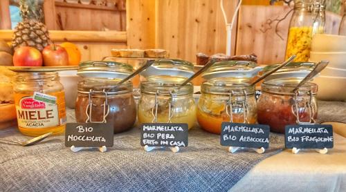 a table with jars of food on a table at Eco-Baita Natura Spensierata in Canale San Bovo