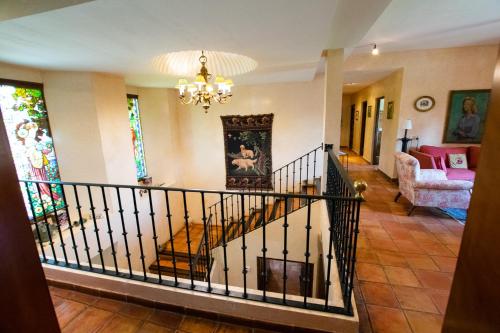 a staircase in a living room with a chandelier at Finca el Consul in Logroño