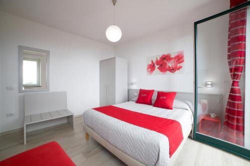a bedroom with a bed with red pillows at Villa Bellatrix in Massa Lubrense