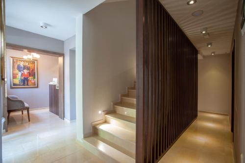 a staircase in a house with a wooden wall at Hotel Twelve by Aycon in Budva
