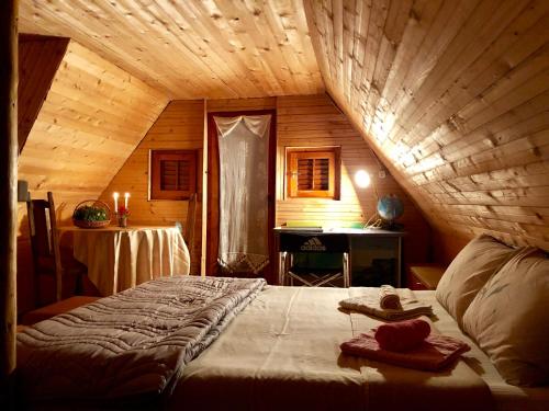 a bedroom with a large bed in a wooden room at Villa ORKA Pelister - Forest Zone in Bitola