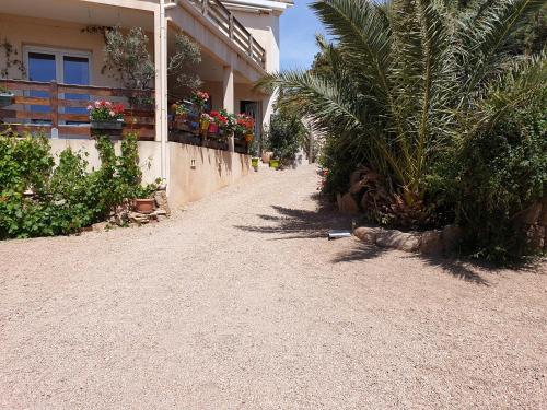 a dirt road next to a house with plants at casabellavista in Bonifacio