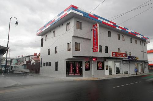 a building on the corner of a street at Hotel San José in San José