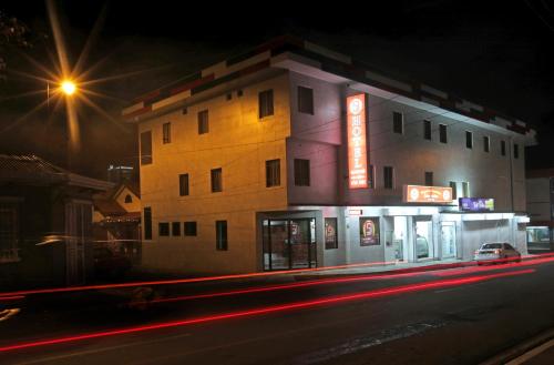 a building with neon signs on the side of a street at Hotel San José in San José