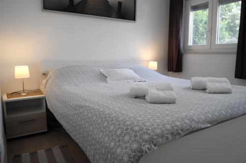 a bedroom with a large bed with two pillows on it at Apartment Mate in Zadar