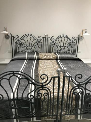 a black bed with a black metal frame at Gelsomino Rooms Ravello in Ravello