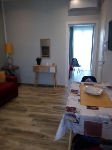 a living room with a table and a couch at Case Vacanza Le Casette in Santo Stefano di Camastra