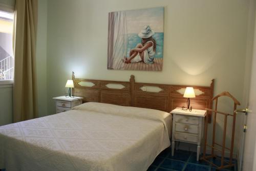 a bedroom with a bed and two tables with lamps at Luigi Apartments&Rooms in Pula