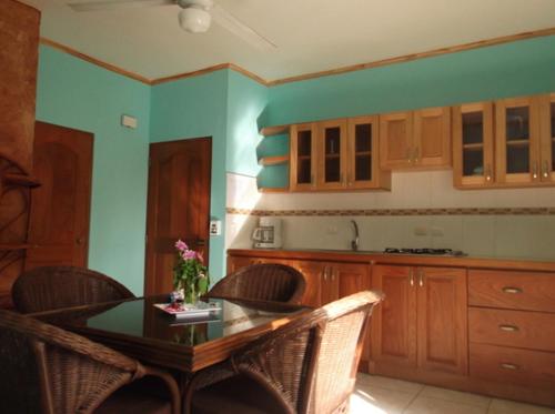 a kitchen with a table and chairs in a room at Aparthotel Michaela in Sosúa