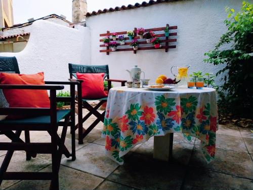 a table with a plate of food on a patio at Garden's House in Spata