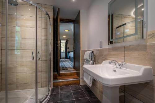 a bathroom with a sink and a shower at Edinbane Lodge in Edinbane
