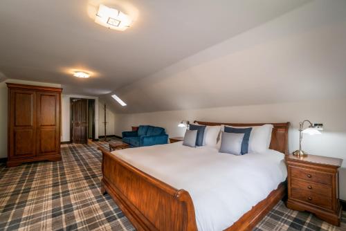 a bedroom with a large bed and a couch at Edinbane Lodge in Edinbane