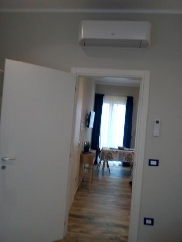 an empty room with a hallway with a table and a window at Case Vacanza Le Casette in Santo Stefano di Camastra