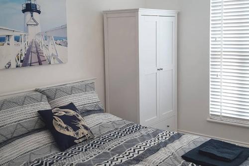 a bedroom with a bed and a large window at Margate Mews 150m From Sea Front and Dreamland in Margate