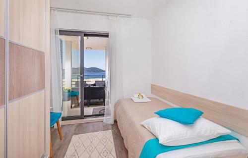 a bedroom with a bed and a view of the ocean at Apartmani D & J with Heated Pool & Stunning Sea View in Orasac