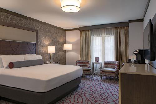 a hotel room with a bed and a television at Horseshoe Black Hawk, A Caesars Destination in Black Hawk