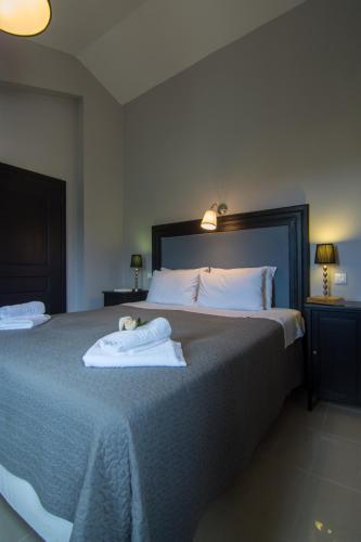 a bedroom with a bed with two towels on it at Villa Elaia Suites & Apartments No.1 in Gaios