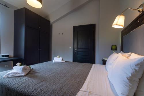a bedroom with a large bed with two towels on it at Villa Elaia Suites & Apartments No.1 in Gaios