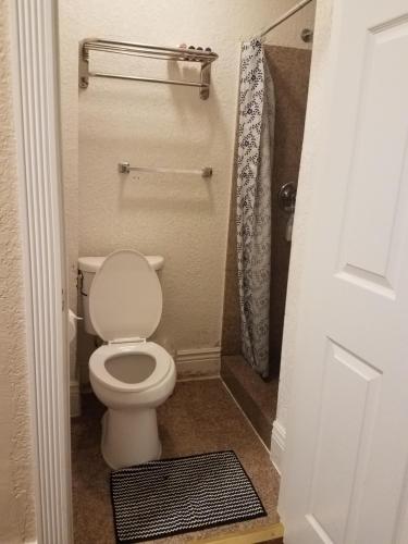 a small bathroom with a toilet and a shower at Orange Village Hostel in San Francisco