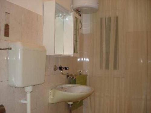 a bathroom with a sink and a mirror at Holiday home Boris - close to sea in Slatine