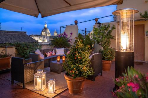 a patio with plants and lights on a roof at Sant'Ivo Apartments in Rome