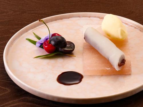 a plate with a piece of cheese and other foods at NIPPONIA HOTEL Takehara Saltworks Town in Takekara