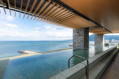 a view of the ocean from the balcony of a house at REX HOTEL Beppu in Beppu