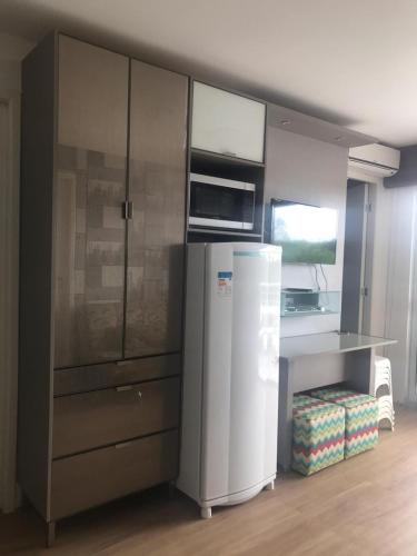 a kitchen with a refrigerator and a counter at GRAN LENÇOIS FLAT in Barreirinhas
