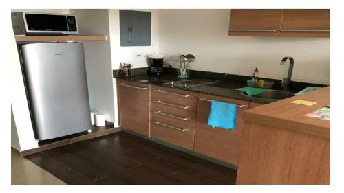 a kitchen with a refrigerator and a sink at Playa Blanca in Playa Blanca
