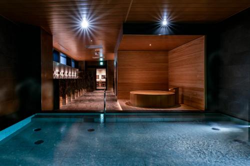a pool in the middle of a room with a table at Vessel Hotel Campana Susukino in Sapporo