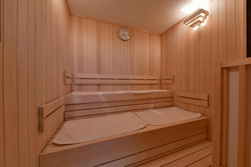 an empty sauna with a clock on the wall at Vessel Hotel Campana Susukino in Sapporo
