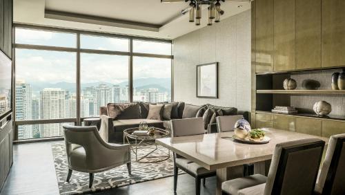 a living room with a couch and a table at Four Seasons Hotel Kuala Lumpur in Kuala Lumpur