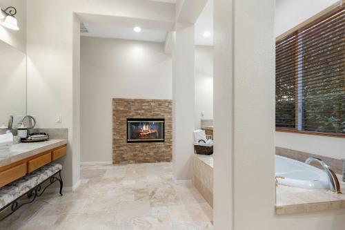 a bathroom with a fireplace and a tub at PGA West Golf Course Pool & Spa Home in La Quinta