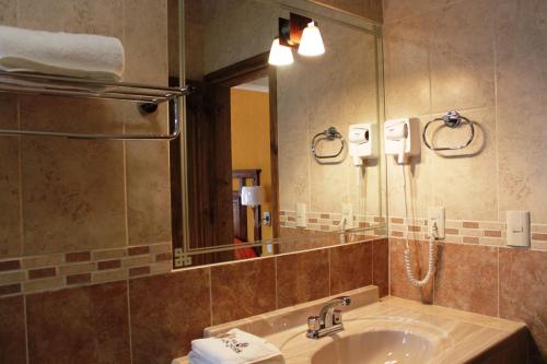 a bathroom with a sink and a mirror at Hotel San Jose in San Cristóbal de Las Casas