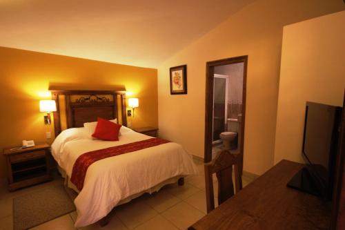 Llit o llits en una habitació de Hotel San Jose