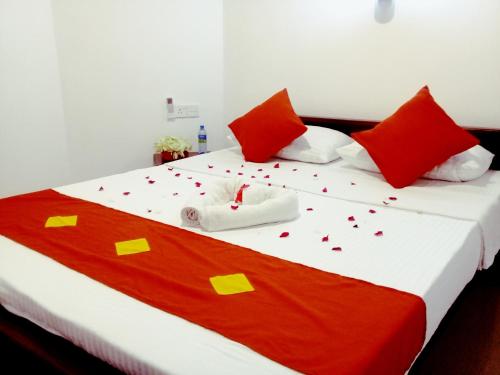 a bedroom with a bed with confetti on it at Green Edge Residences in Dambulla